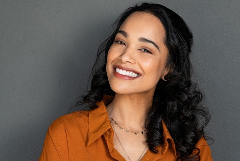 Woman in orange shirt smiling