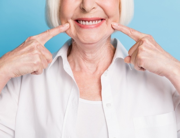 Senior woman pointing to her smile