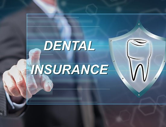 Shoulder to waist view of a man in a suit holding his finger to a screen that says Dental Insurance