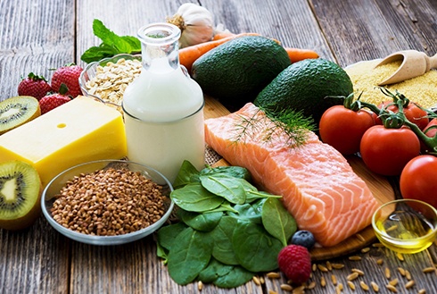 A variety of healthy foods laid out on a wooden table