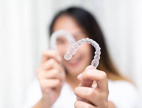 Clear aligner lying on gray surface